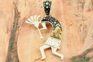 This Pendant is a work of art! Beautiful Starry Night Design at Monument Valley with a Shooting Star! Featuring Picture Jasper, and Black Jade inlaid in Sterling Silver Pendant. Beautiful Fire and Ice Lab Opal Moon! Reversible Pendant with Contemporary Sterling Silver Design.  Free 18" Sterling Silver Chain with Purchase of Pendant. Kokopelli Pendant Designed by Navajo Artist Calvin Begay. Signed by the artist.